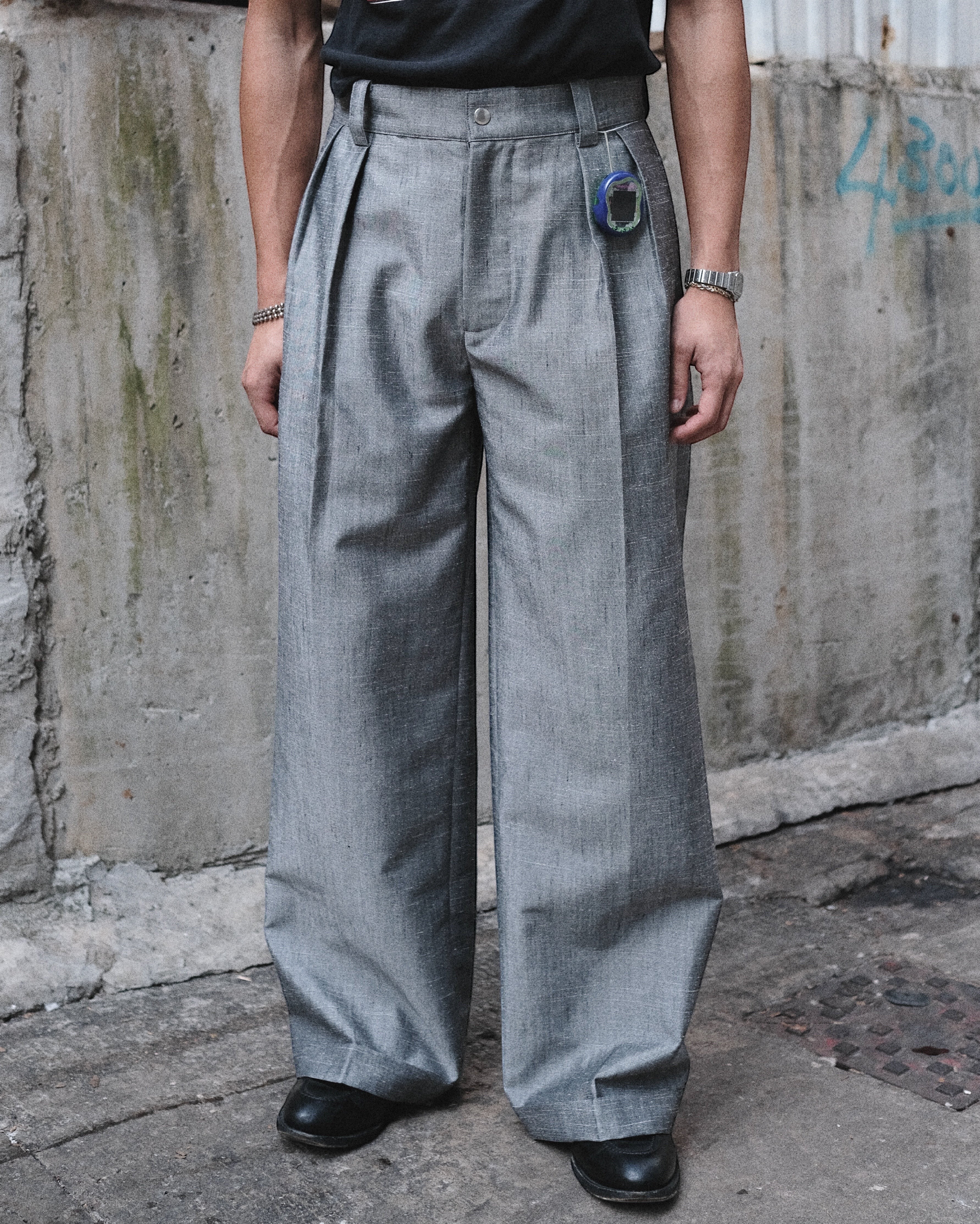 MEG.S 007 Pleated Chino in grey wool-silk blend, wide-leg with front pleats and ball-drop zipper fly.