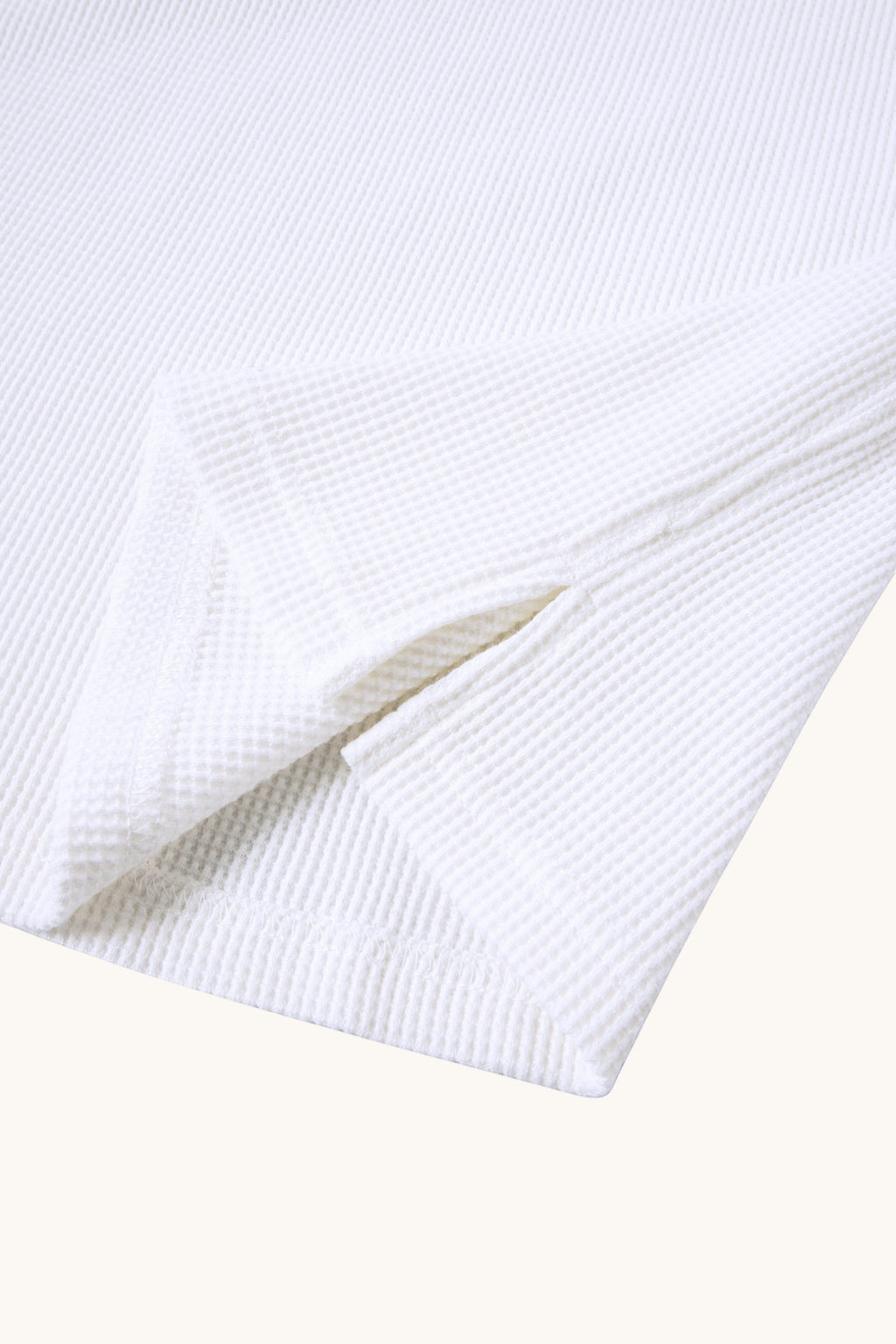 MEG.S white 100% cotton waffle knit long sleeve shirt with wide neck and split hem detail.