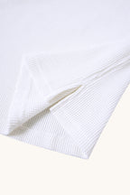 MEG.S white 100% cotton waffle knit long sleeve shirt with wide neck and split hem detail.