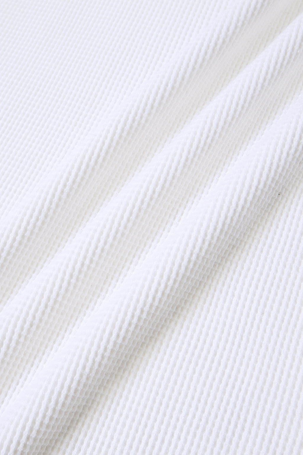 MEG.S white 100% cotton long sleeve waffle knit shirt with wide neck and split hem.