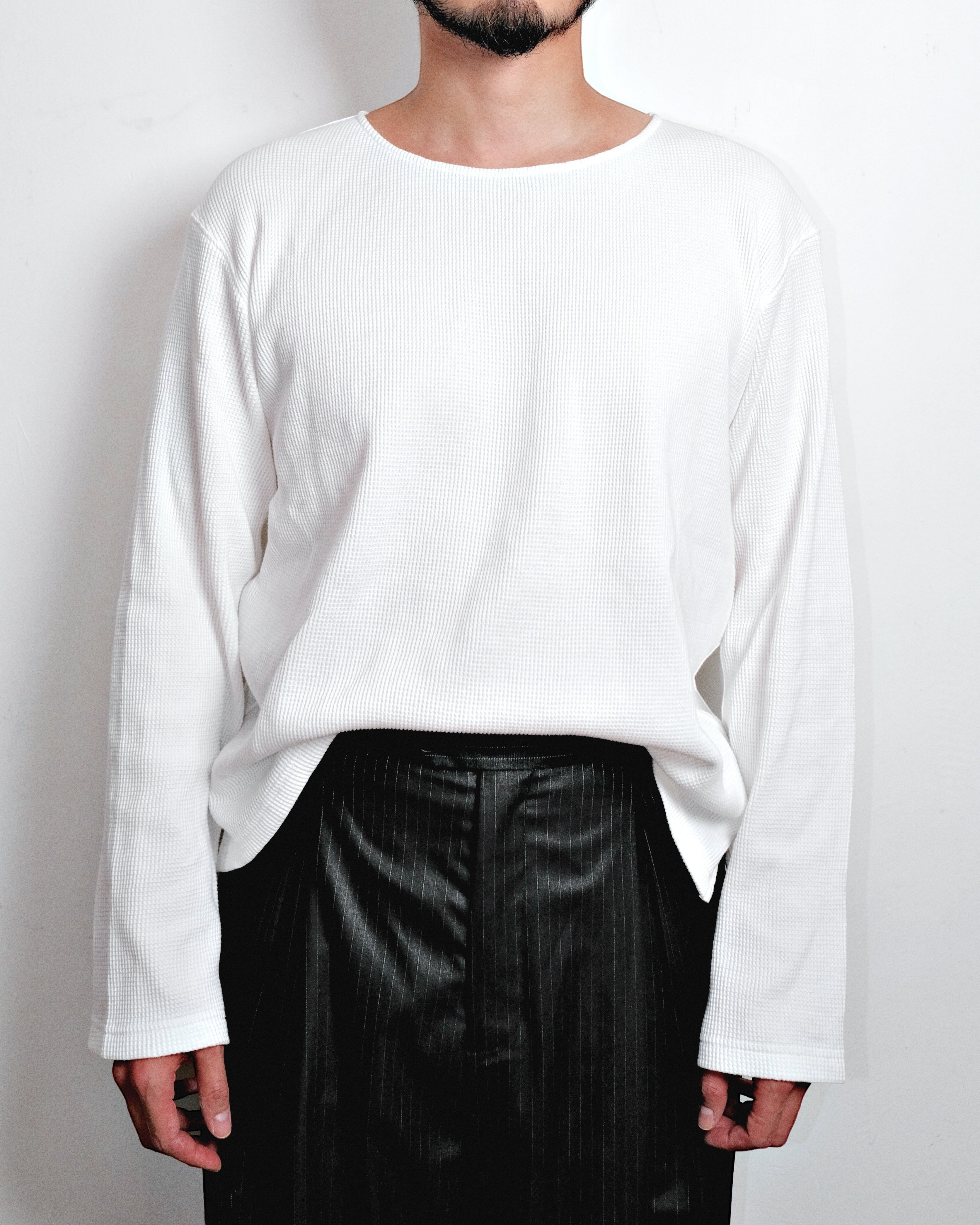 MEG.S white 100% cotton long-sleeve waffle knit shirt with a wide neck and split hem.